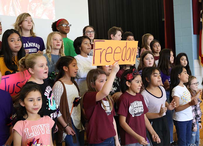 students standing with posters