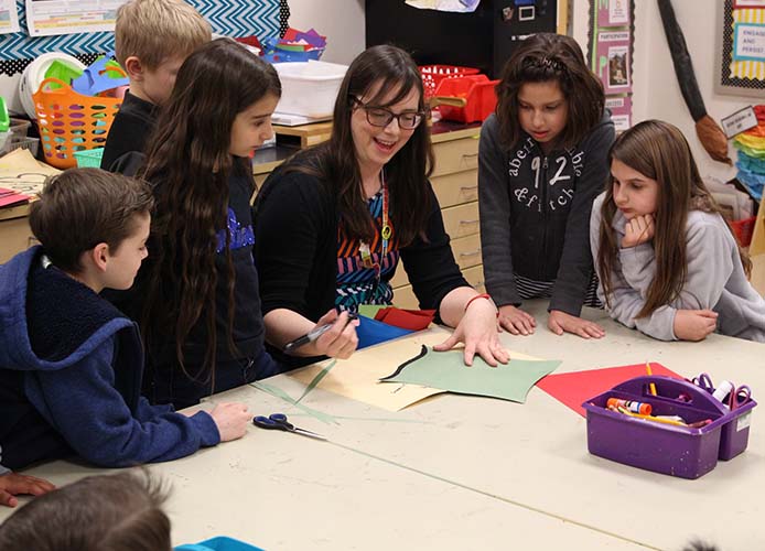 teacher and kids working together