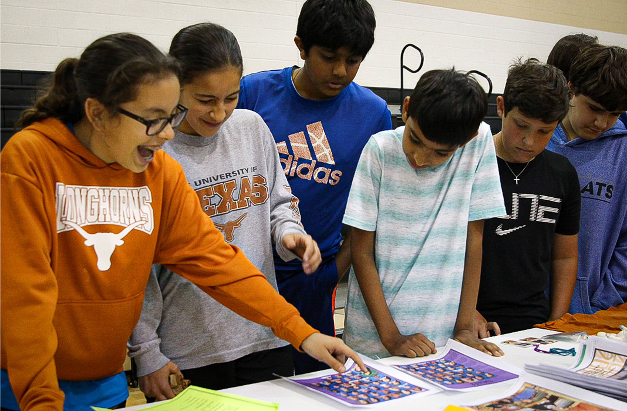 students looking at a yearbook