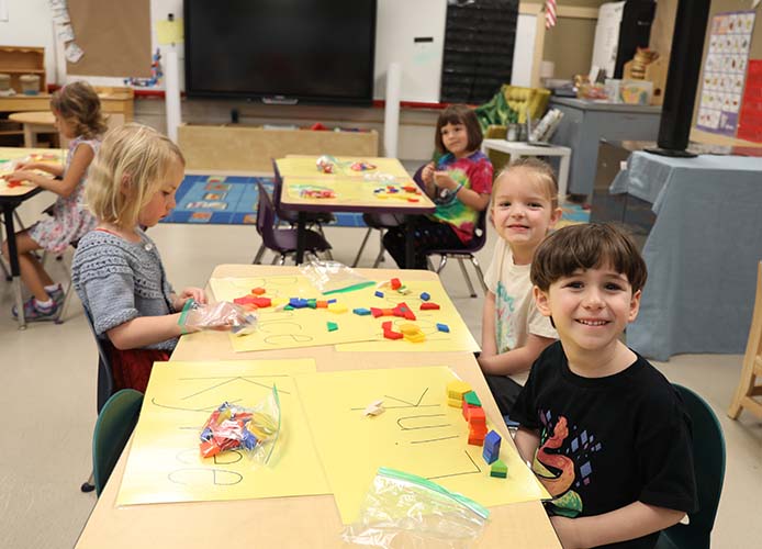 students smiling in a classroom