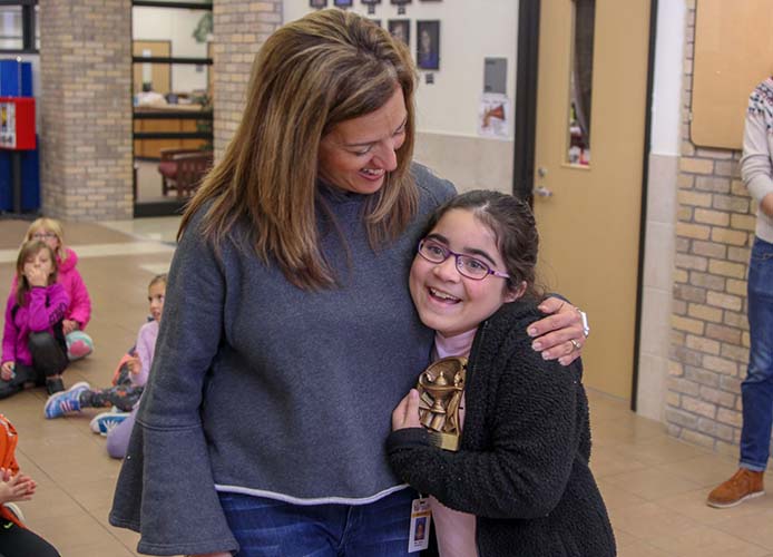 Teacher hugging student