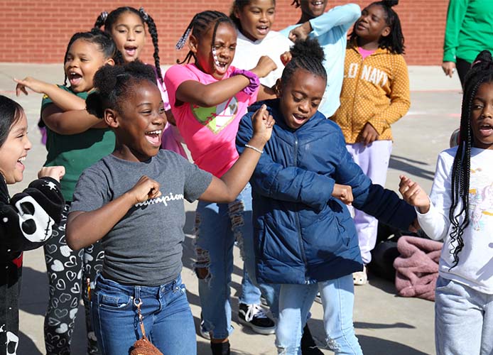 Students dancing outside