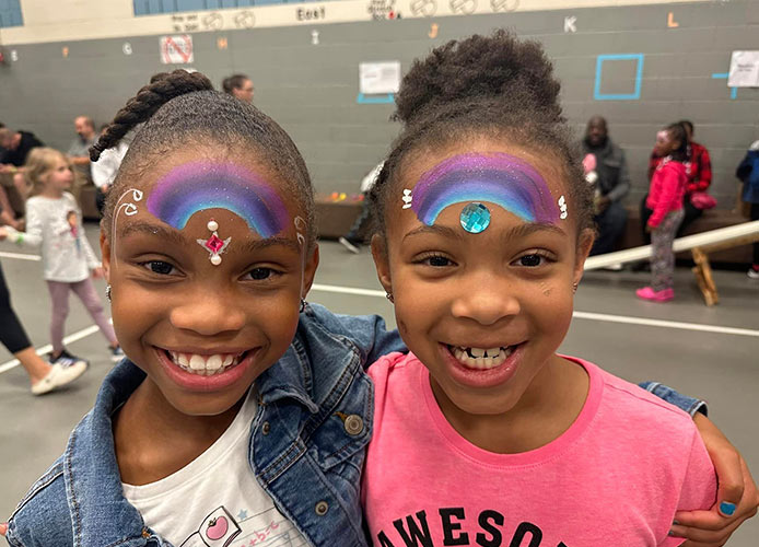 Students smiling with face paint on
