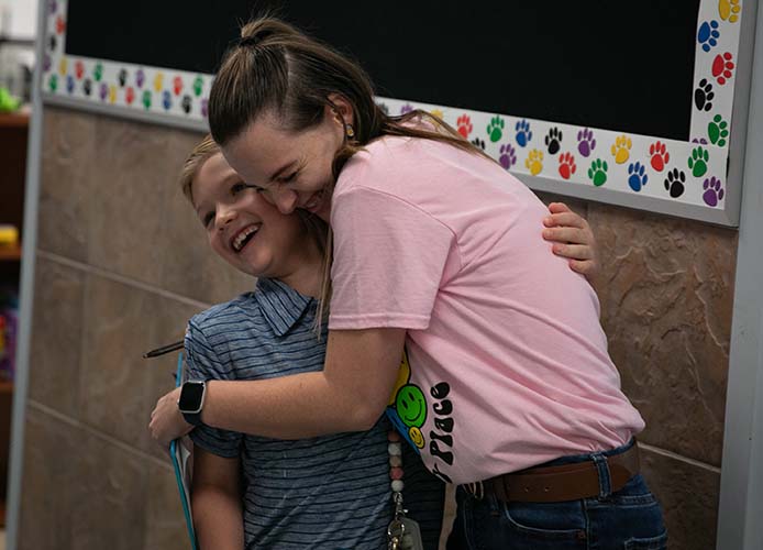 teacher hugging a student