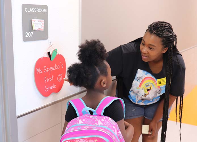 parent showing child a sign